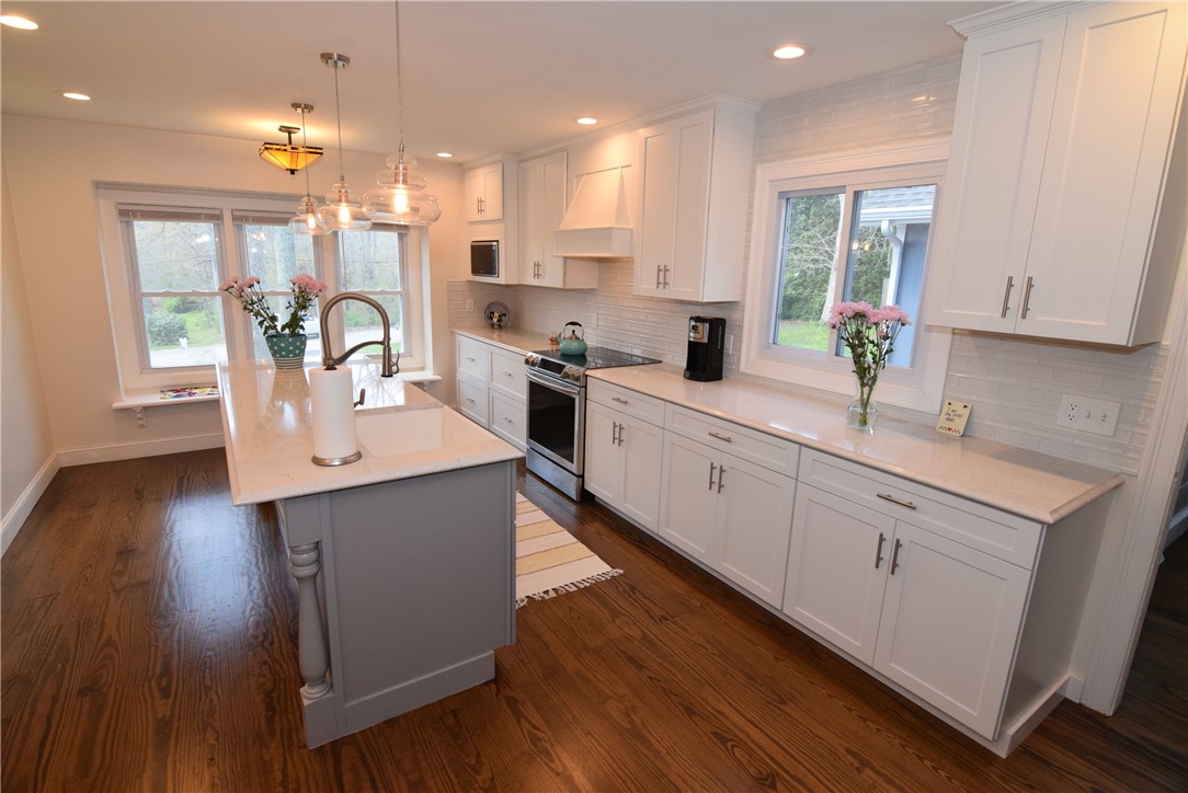 Huge kitchen with long center island, window seat and all new appliances and cabinets.