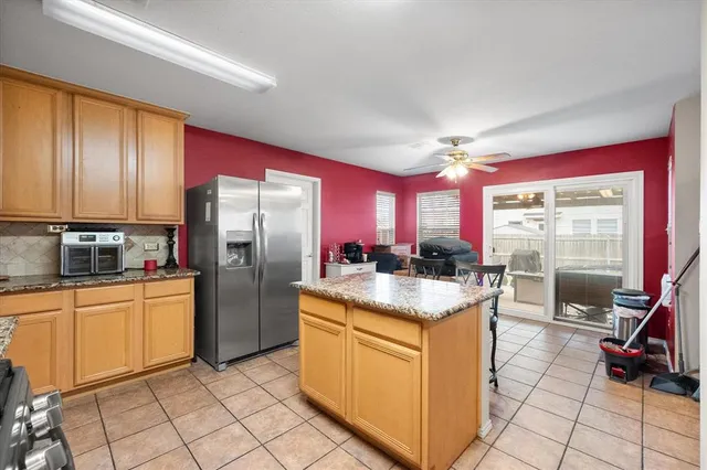 a kitchen with stainless steel appliances granite countertop a stove oven and a refrigerator