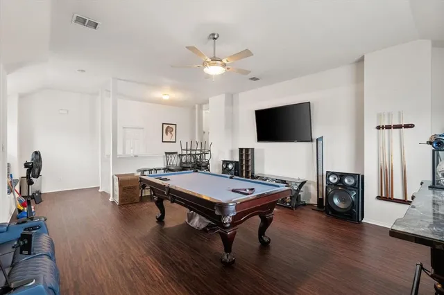 a view of a workspace with furniture and wooden floor