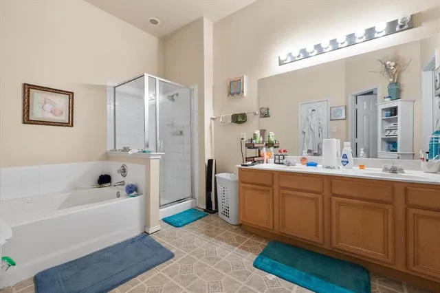 a bathroom with a tub sink and mirror
