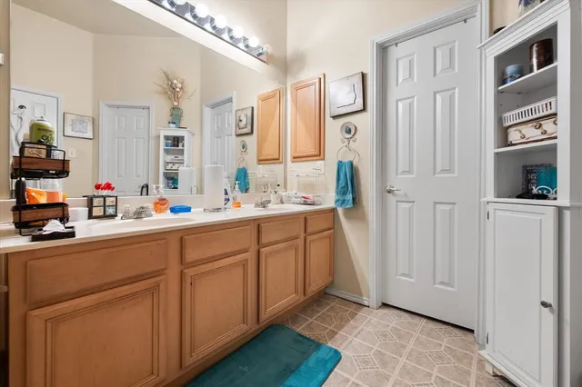 a bathroom with a double vanity sink a mirror and a shower