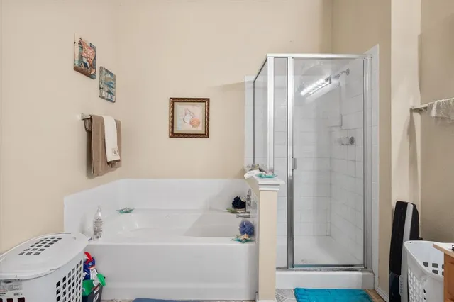 a bathroom with a bathtub and a shower