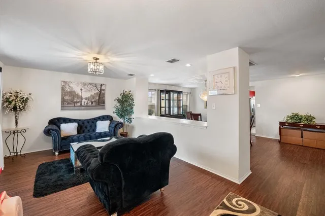 a living room with furniture and a chandelier