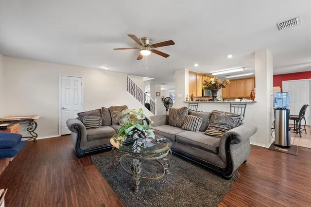 a living room with furniture and wooden floor