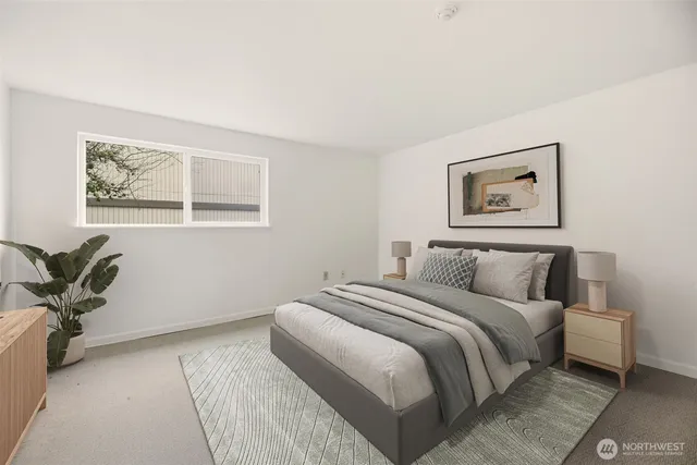 a spacious bedroom with a bed and a potted plant