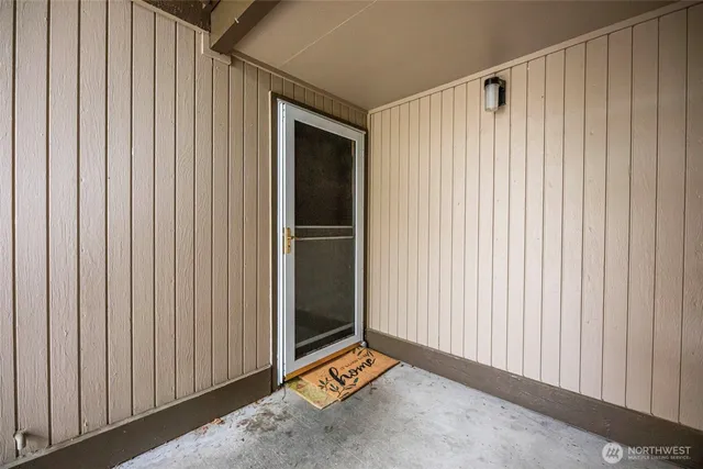 a backyard of a house with plants and large trees