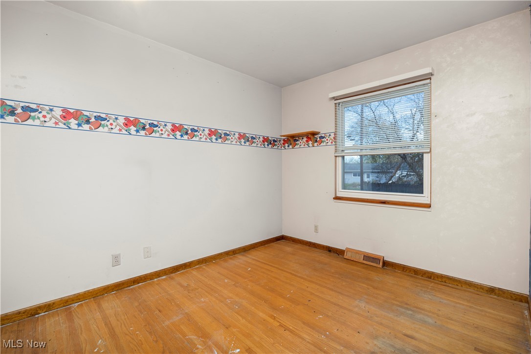 2156 South Oldgate Road Sandusky, OH 44870 - Photo 4 of 6 Empty room featuring hardwood / wood-style floors and baseboards