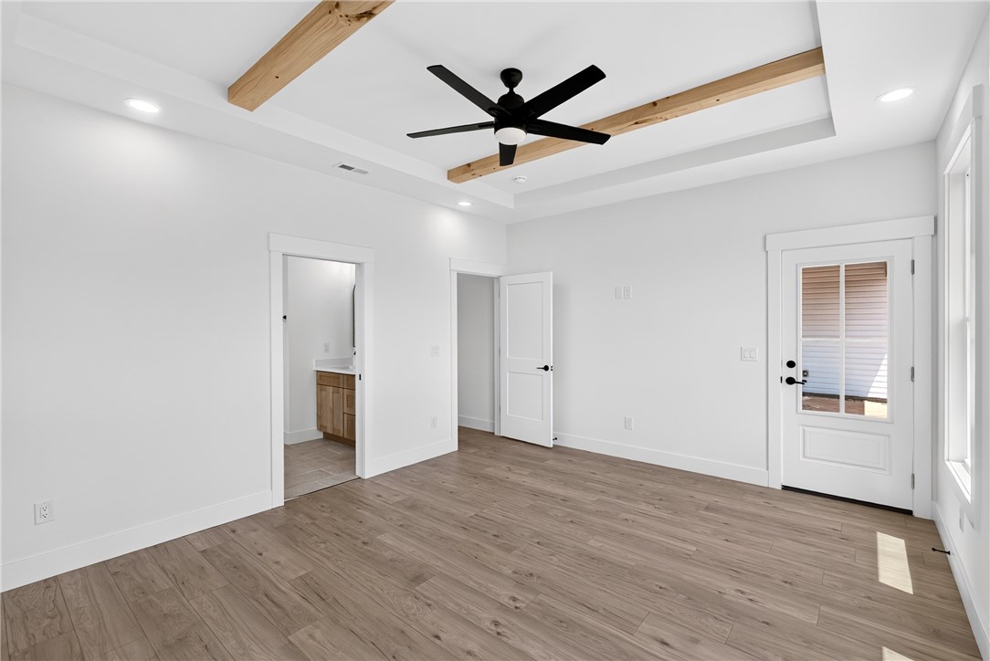 424 Blume Road Anderson, SC 29625 - Photo 18 of 30 A generously sized primary bedroom features exposed beam accents and an ensuite bathroom access.