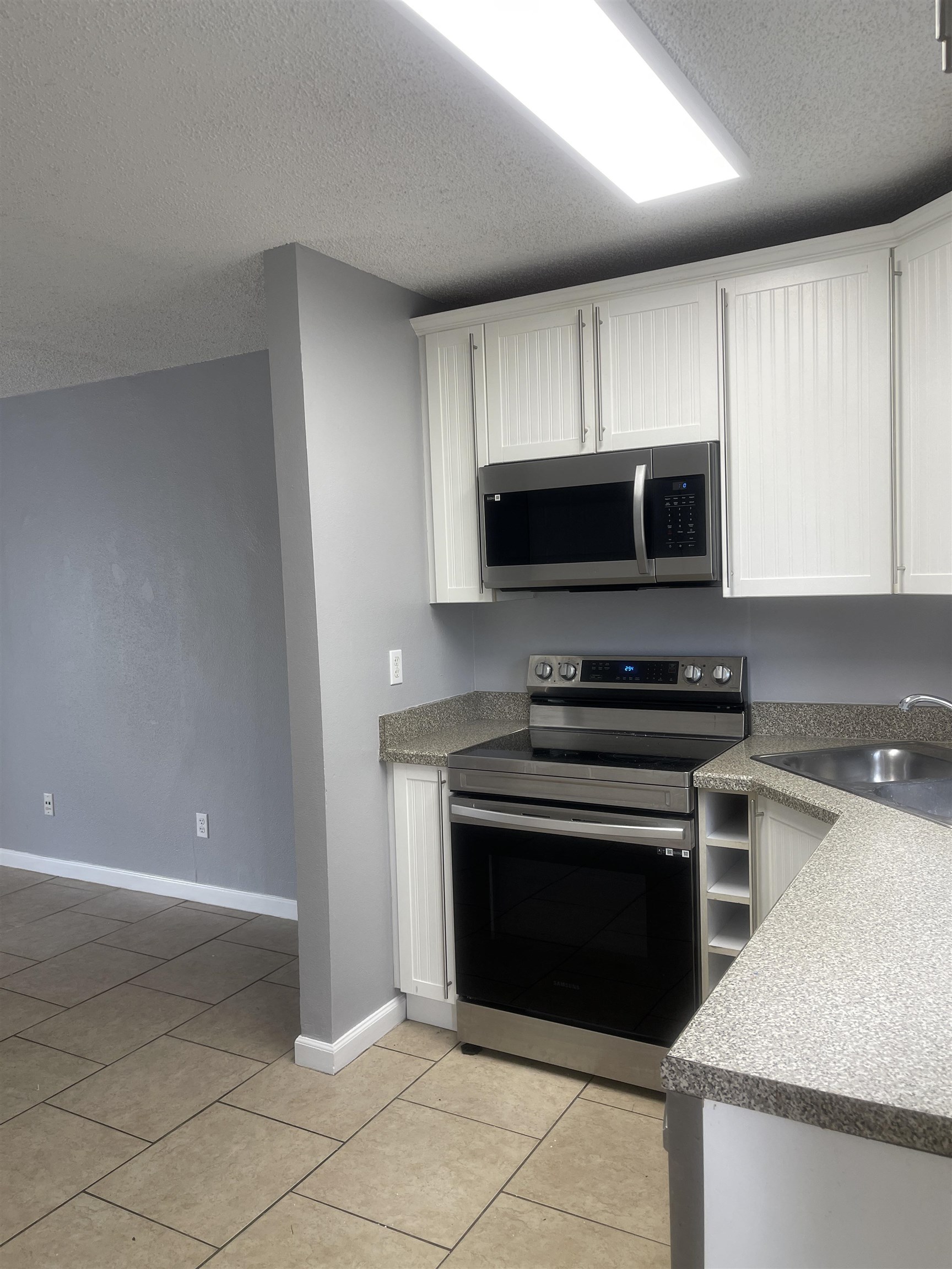 4420 Carter Road, Unit 58 St. Augustine, FL 32086 - Photo 3 of 13 a kitchen with a stove and a microwave
