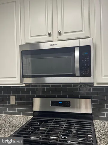 a kitchen with wooden cabinets