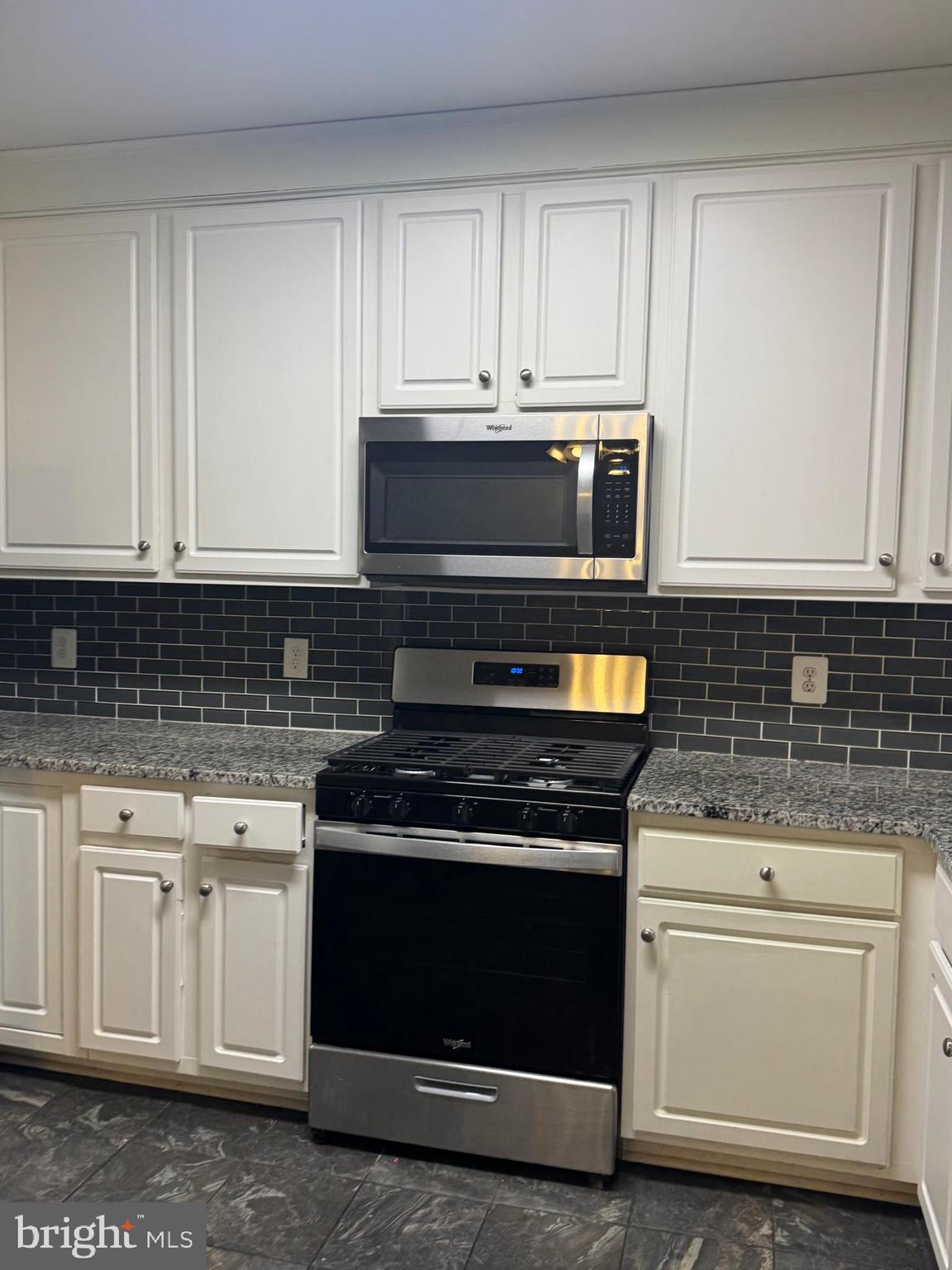 3850 Koval Lane Woodbridge, VA 22192 - Photo 12 of 61 a kitchen with granite countertop white cabinets and stainless steel appliances