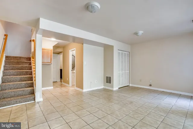 an empty room with a empty space and windows