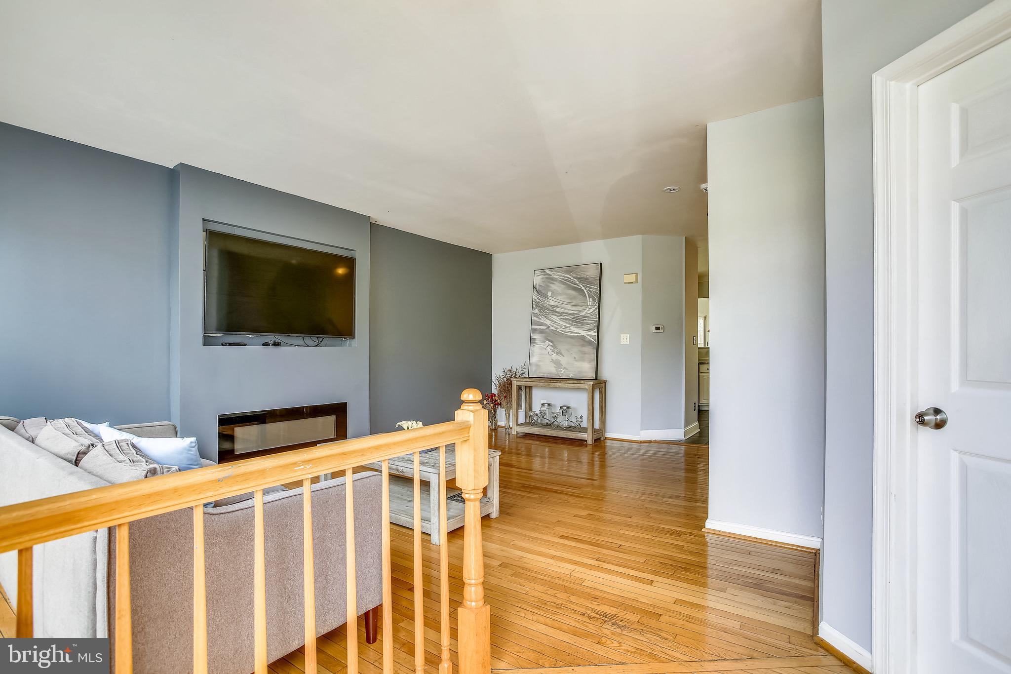 3850 Koval Lane Woodbridge, VA 22192 - Photo 4 of 61 a living room with furniture wooden floor and a flat screen tv