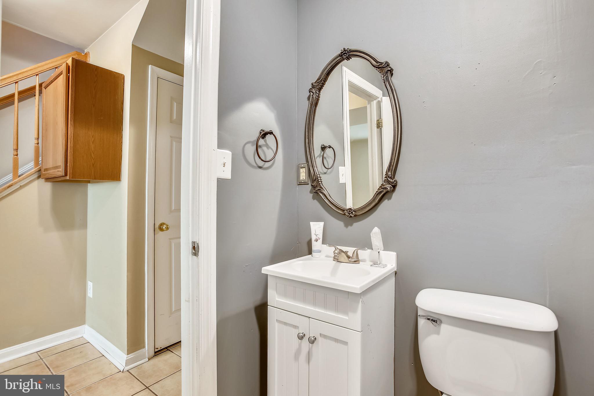 3850 Koval Lane Woodbridge, VA 22192 - Photo 43 of 61 a bathroom with a toilet sink and mirror