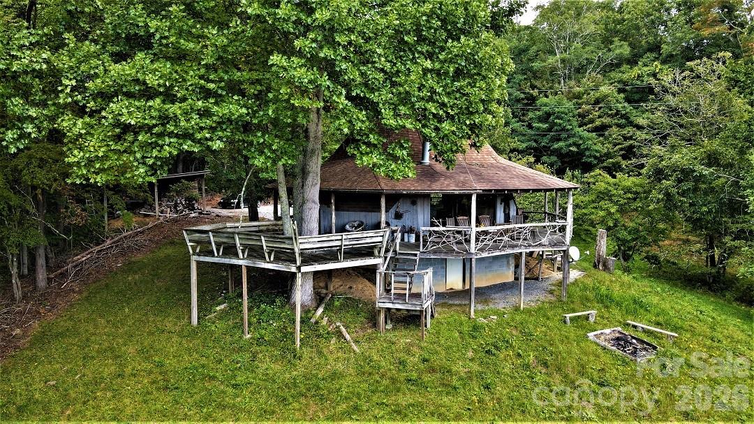 745 Broom Road Tuckasegee, NC 28783 - Photo 1 of 42 a backyard of a house with table and chairs