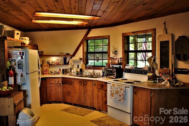 a kitchen with stainless steel appliances a stove a sink and a refrigerator