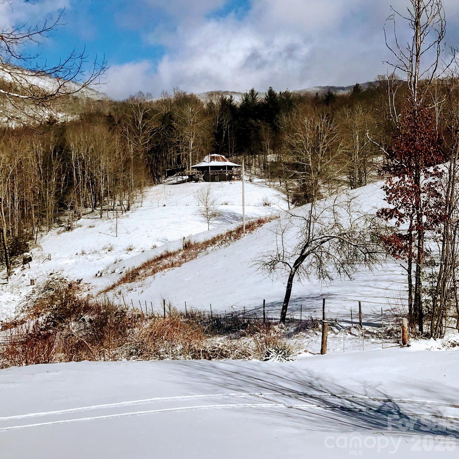 745 Broom Road Tuckasegee, NC 28783 - Photo 30 of 42 a view of a house with a yard covered in snow