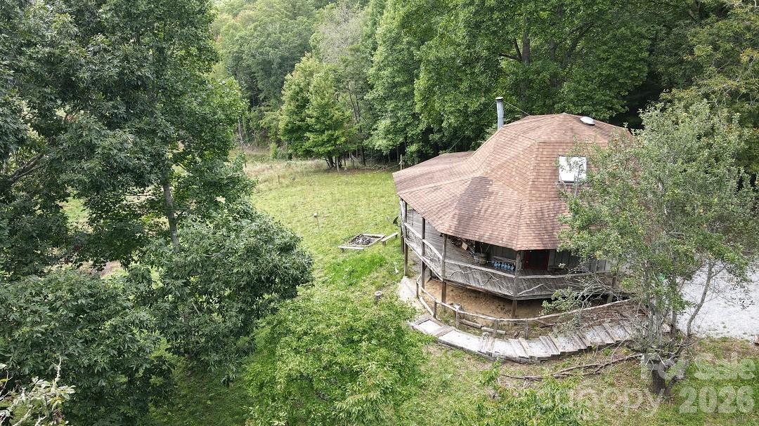 745 Broom Road Tuckasegee, NC 28783 - Photo 3 of 42 a backyard of a house with a yard and outdoor seating