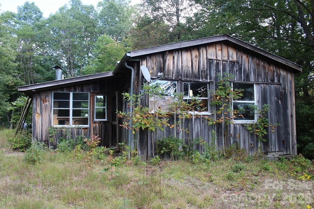 745 Broom Road Tuckasegee, NC 28783 - Photo 39 of 42 a backyard of a house with plants and outdoor seating