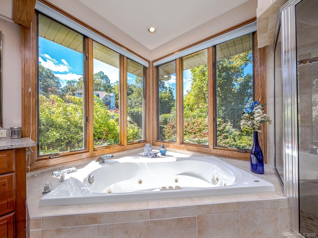 270 Country Ridge Road Laurel Park, NC 28739 - Photo 11 of 39 a bath tub sitting in front of a window