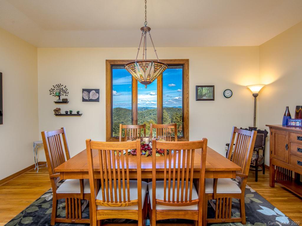 270 Country Ridge Road Laurel Park, NC 28739 - Photo 12 of 39 a view of a dining room with furniture window and wooden floor