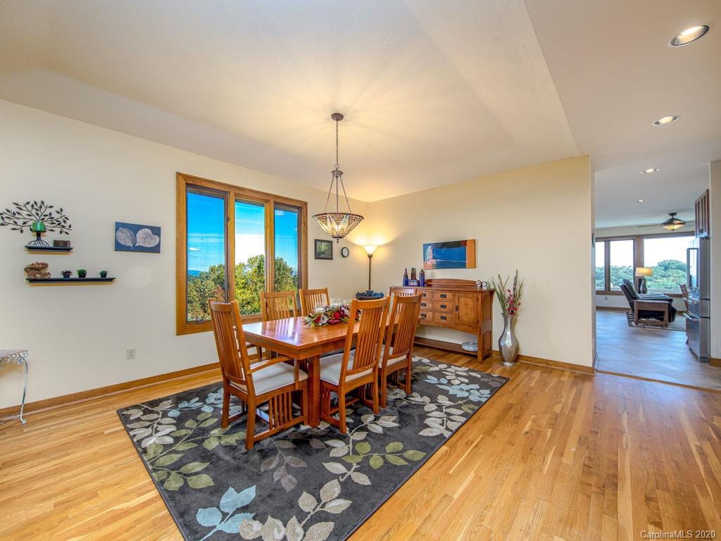270 Country Ridge Road Laurel Park, NC 28739 - Photo 13 of 39 a view of a dining room with furniture a chandelier and wooden floor