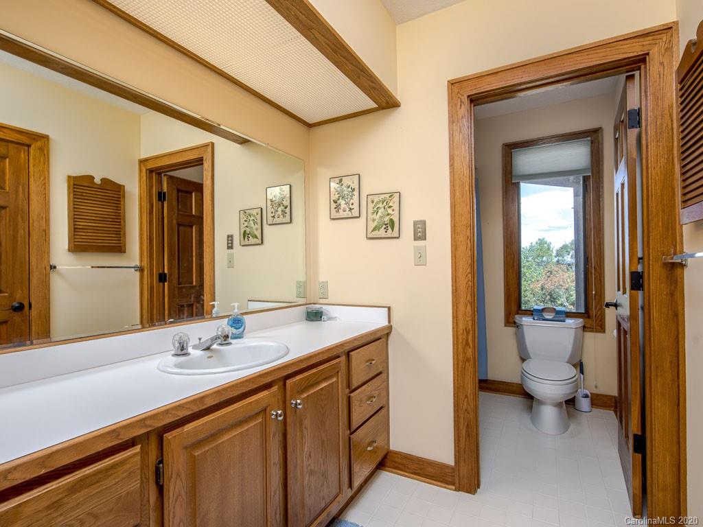 270 Country Ridge Road Laurel Park, NC 28739 - Photo 28 of 39 a bathroom with a double vanity sink toilet and shower