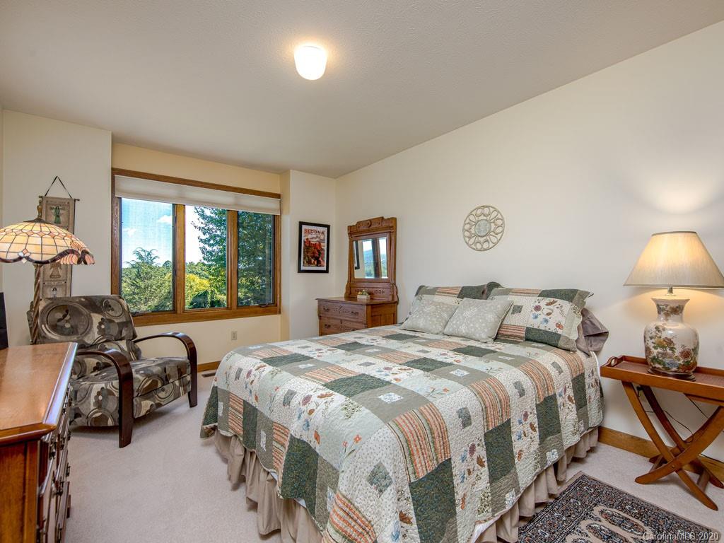 270 Country Ridge Road Laurel Park, NC 28739 - Photo 29 of 39 a bed room with a bed and a lamp