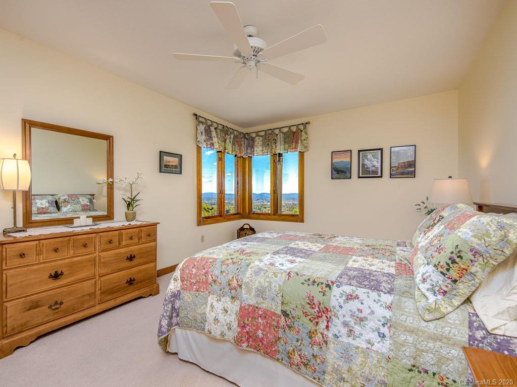 270 Country Ridge Road Laurel Park, NC 28739 - Photo 30 of 39 a bedroom with a bed and a dresser