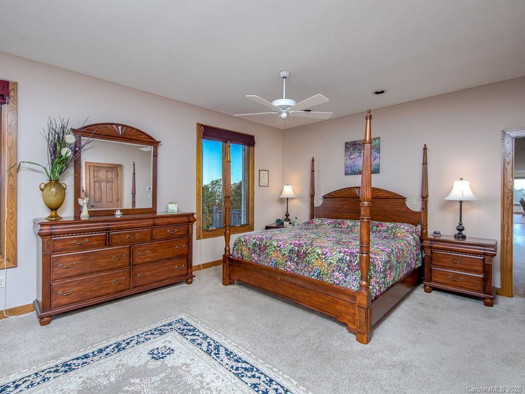 270 Country Ridge Road Laurel Park, NC 28739 - Photo 8 of 39 a bedroom with a bed and a dresser