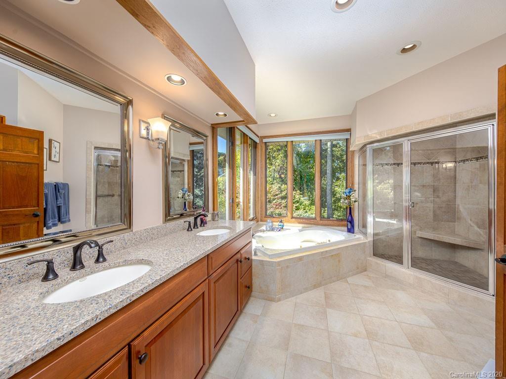 270 Country Ridge Road Laurel Park, NC 28739 - Photo 10 of 39 a large bathroom with a granite countertop tub sink shower and mirror