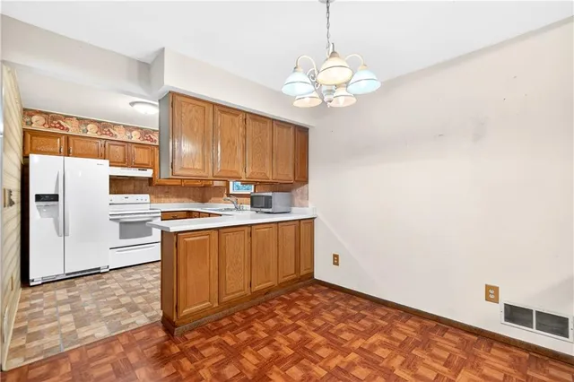 a view of a kitchen with electric appliances
