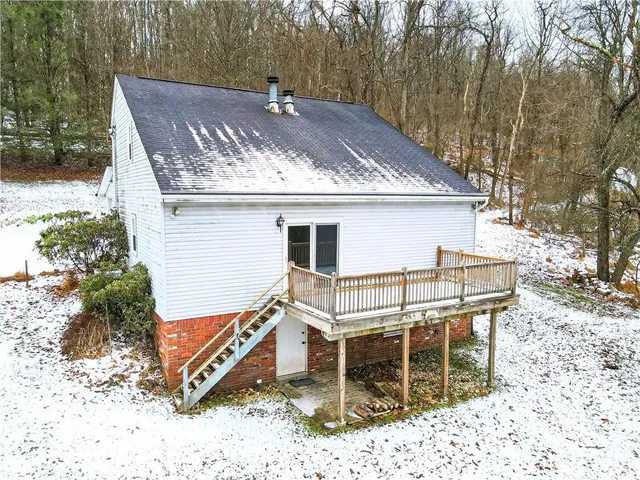 an empty room with a ceiling fan and a window
