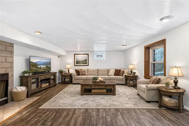 a view of empty room with wooden floor and fireplace