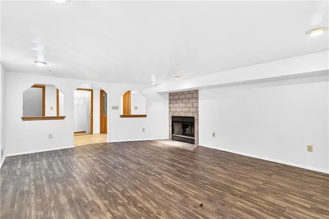 an empty room with wooden floor and closet