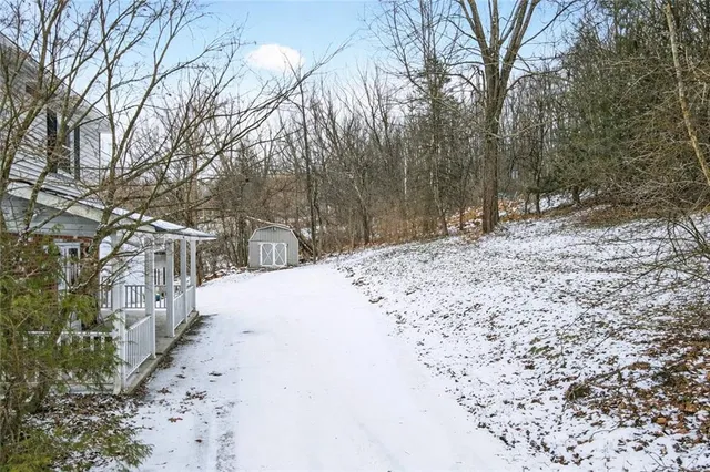 a view of a bedroom with wooden floor and cabinet