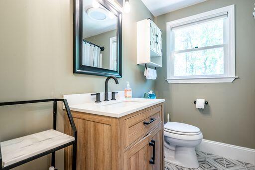 12 Pinehurst Drive Monument Beach, MA 02532 - Photo 27 of 31 a bathroom with a toilet a sink a vanity and mirror