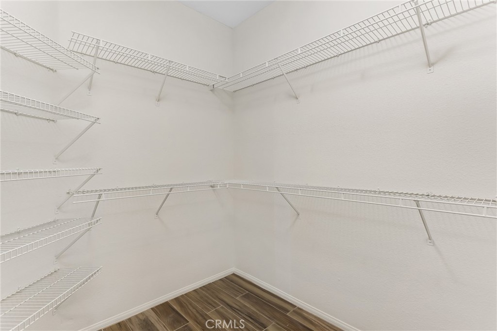 8742 Feathertop Road Riverside, CA 92508 - Photo 31 of 40 Walk in closet of main bedroom. Note the organized shelf racks!