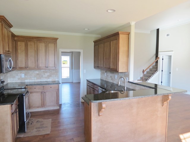 904 Rainbow Springs Road Macon, GA 31216 - Photo 12 of 16 a kitchen with stainless steel appliances granite countertop a sink stove and refrigerator