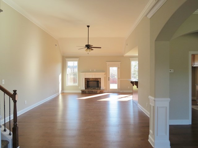 904 Rainbow Springs Road Macon, GA 31216 - Photo 6 of 16 a view of an empty room with wooden floor fireplace and a window
