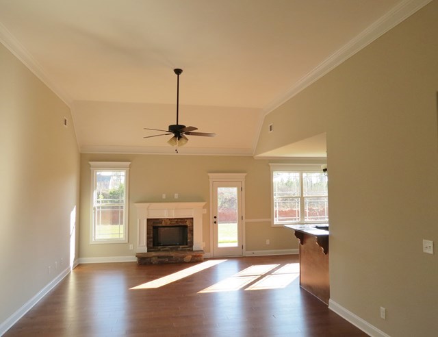 904 Rainbow Springs Road Macon, GA 31216 - Photo 7 of 16 a view of an empty room with a fireplace and a window
