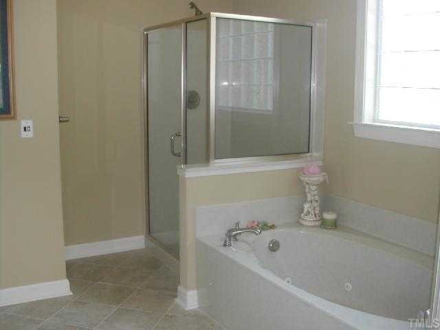 2458 Mitchell Road Angier, NC 27501 - Photo 5 of 6 a bath tub sitting next to a white sink and a shower