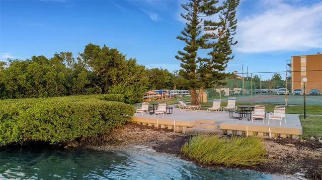 a view of a lake with a house swimming pool and outdoor space