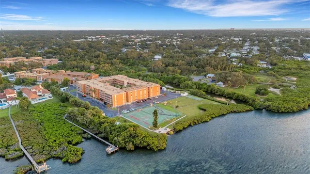 an aerial view of a house with a garden and lake view
