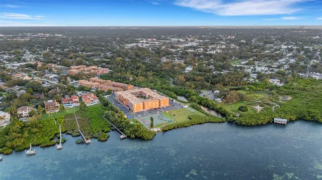 an aerial view of residential houses with outdoor space and trees