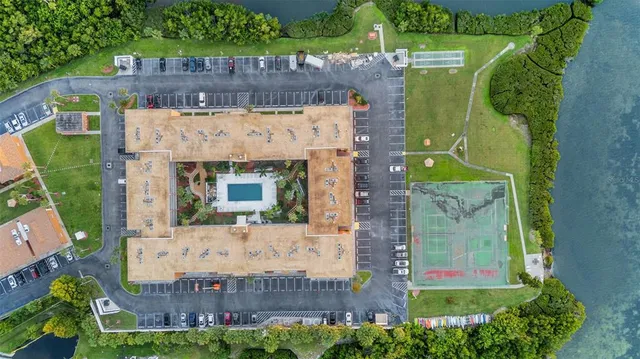 an aerial view of a house with a yard and potted plants