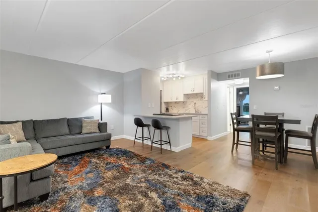 a living room with furniture a dining table and kitchen view
