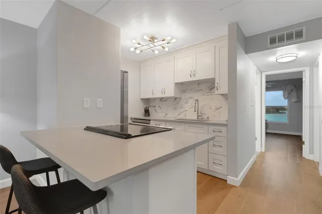 a kitchen with a table chairs and a refrigerator