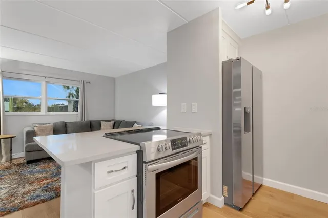 a stove top oven sitting inside of a kitchen