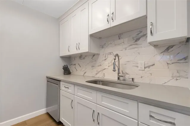 a sink with white cabinets